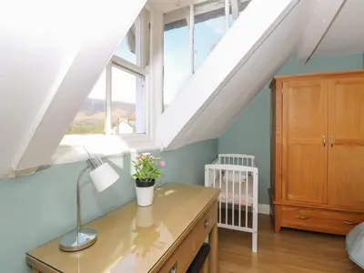 an attic room with a desk and a window at Baystones in Keswick