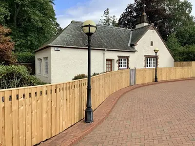 a street light in front of a fence at Cottage in Ayr
