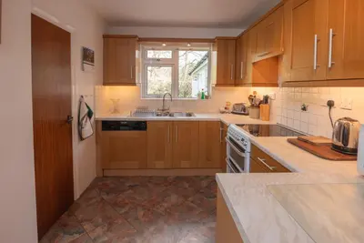 a kitchen with wooden cabinets and a sink at Beckfoot Chapel Stile - Ambleside in Chapel Stile