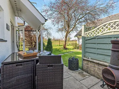 an outdoor patio with a grill and a house at 1 Bed in Bassenthwaite 91211 in Bassenthwaite Lake
