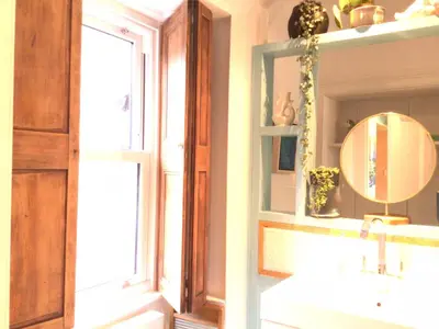 a bathroom with a sink and a mirror and a window at Mansefield Rooms in Lockerbie