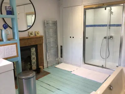 a bathroom with a shower and a glass shower backdoor at Mansefield Rooms in Lockerbie