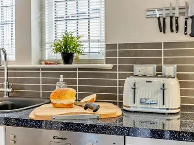 a kitchen counter with a cutting board with a loaf of bread at 4 Bed in Crosby-on-Eden 94398 in Crosby