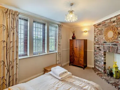 a bedroom with a bed and a brick fireplace at 4 Bed in Crosby-on-Eden 94398 in Crosby