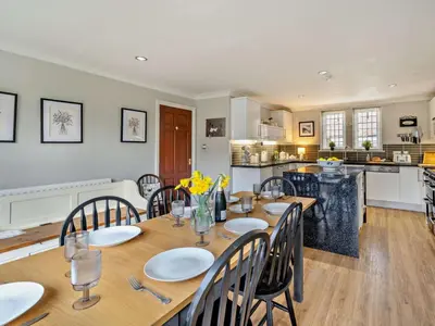 a dining room with a table and chairs and a kitchen at 4 Bed in Crosby-on-Eden 94398 in Crosby