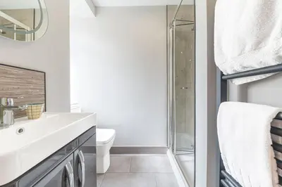 a bathroom with a sink and a shower at Blue Sky Cottage in Keswick