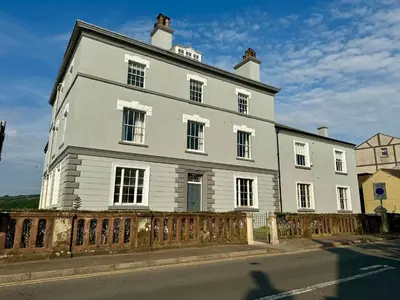 a large white house on the side of a street at Grindal Studio Apartments - Newly Opened Luxury Accommodation in St Bees