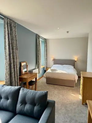 a bedroom with a bed and a couch at Grindal Studio Apartments - Newly Opened Luxury Accommodation in St Bees