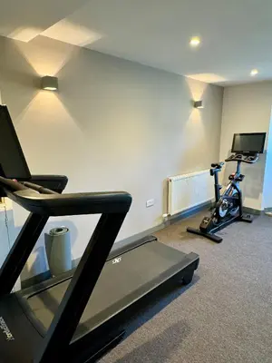 a room with a gym with a treadmill and a exercise bike at Grindal Studio Apartments - Newly Opened Luxury Accommodation in St Bees
