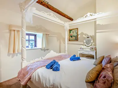 a bedroom with a white bed with blue towels on it at 3 Bed in Eskdale 94529 in Eskdale