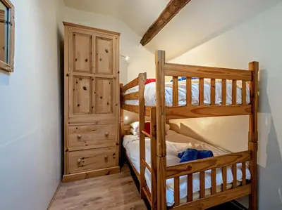 two bunk beds in a room with a closet at 3 Bed in Eskdale 94529 in Eskdale