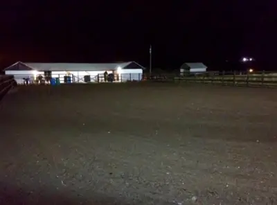 a house with lights on in a field at night at WestLaigh Lrg Luxury Country Farm House 20 min from the city in Glassford