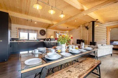a large dining room with a table and a kitchen at 3 Bed in Colvend oc-t28900 in Kippford