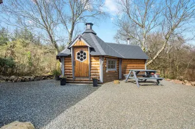 a log cabin with a picnic table in front of it at 3 Bed in Colvend oc-t28900 in Kippford