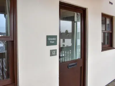 a door to a building with a sign that reads crisis view at Grisedale View - Hewetson Court in Keswick