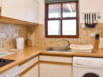 a small kitchen with a sink and a window at Grisedale View - Hewetson Court in Keswick