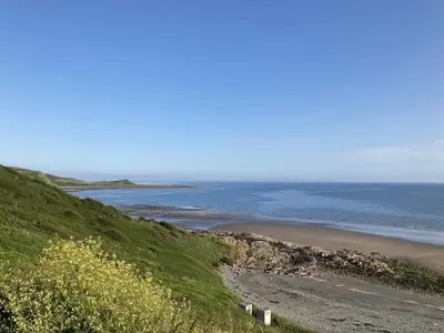 a view of a beach with the ocean in the background at Beautifully Presented 2 Bedroom Static Caravan in Monreith