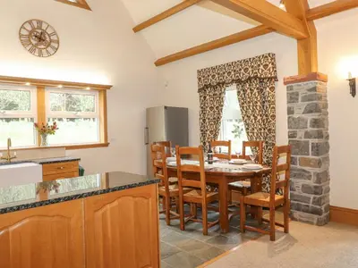 a kitchen and dining room with a table and chairs at Glen View in Dumfries