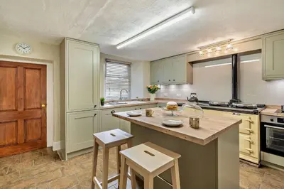 a kitchen with a large island in the middle at 4 Bed in Kinniside oc-c28854 in Frizington