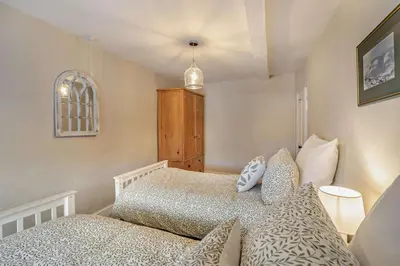 a small bedroom with a bed and a dresser at 4 Bed in Kinniside oc-c28854 in Frizington