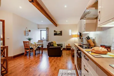 a kitchen and a living room with a table at 1 Bed in Irthington oc-t28309 in Irthington