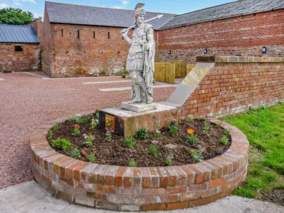 a statue of a woman standing in a garden at 1 Bed in Irthington oc-t28309 in Irthington