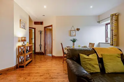 a living room with a couch and a table at 1 Bed in Irthington oc-t28309 in Irthington
