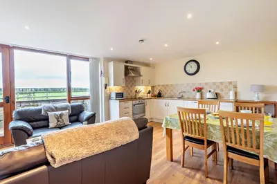 a kitchen and living room with a couch and a table at 2 Bed in Irthington oc-v28308 in Irthington