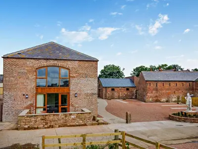 a brick building with a large window on it at 2 Bed in Irthington oc-m28305 in Irthington