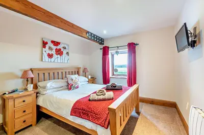 a bedroom with a bed and a window at 2 Bed in Irthington oc-m28305 in Irthington