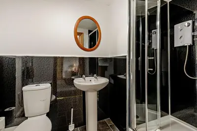 a bathroom with a toilet and a sink and a mirror at 3 Bed in Bowness-on-Solway oc-p28797 in Bowness-on-Solway