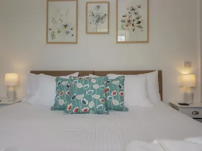 a bedroom with a bed with pillows on it at Dalegarth Hall Farm Cottage 1 in Holmrook