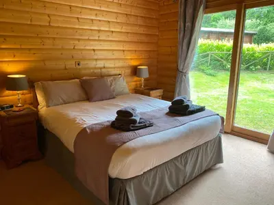 a bedroom with a bed with two hats on it at Kipplochan in Dalbeattie