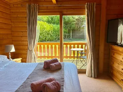 a bedroom with a bed with two teddy bears on it at Kipplochan in Dalbeattie