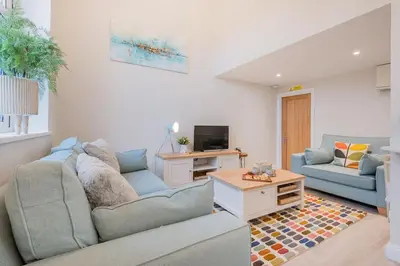 a living room with a couch and a tv at Rockwood- Grasmere family cottage with Hot tub in Grasmere