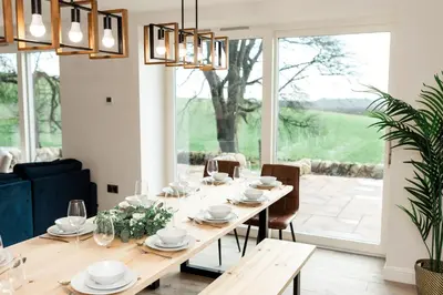 a dining room with a table and chairs at Disdow House in Gatehouse of Fleet