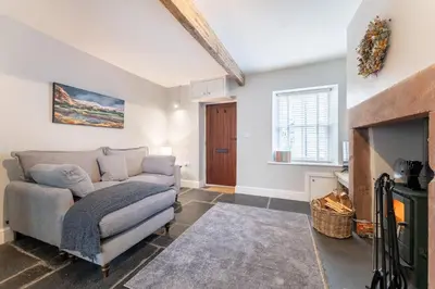 a living room with a couch and a fireplace at Little Ada in Keswick