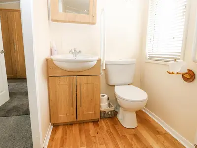 a small bathroom with a toilet and a sink at Plot 32 in Carlisle