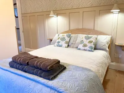 a bed with towels sitting on top of it at Laurel Bank House in Penrith
