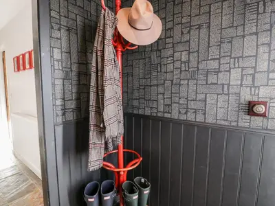 a hat and pairs of shoes on a wall at Smithy House in Dumfries