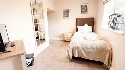 a bedroom with a bed and a mirror at Wheyrigg Hall Hotel in Wheyrigg