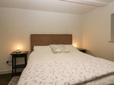 a bedroom with a bed with two night stands at The Barn in Seascale