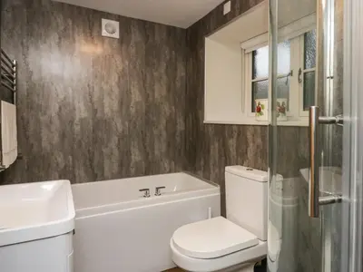 a bathroom with a toilet and a sink and a shower at The Barn in Seascale