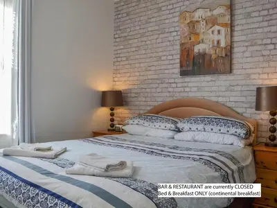 a bedroom with a bed with towels on it at Hope & Anchor, Hadrian's Wall, Port Carlisle, Solway Firth, Area of Natural Beauty in Port Carlisle