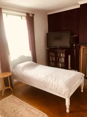 a white bed in a room with a television at Hope & Anchor, Hadrian's Wall, Port Carlisle, Solway Firth, Area of Natural Beauty in Port Carlisle