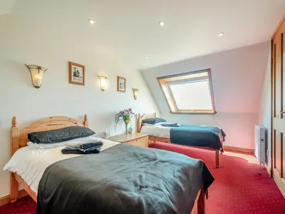 a bedroom with two beds and a window at Barnstable - Uk46888 in Kilmory