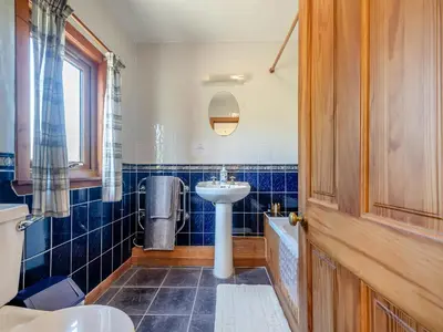 a bathroom with a sink and a toilet at Kilbride Cottage-Uk46886 in Kilmory