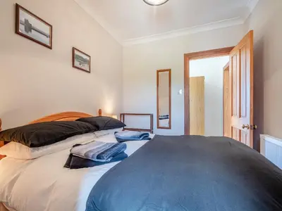 a bedroom with a bed with two pillows on it at Kilbride Cottage-Uk46886 in Kilmory