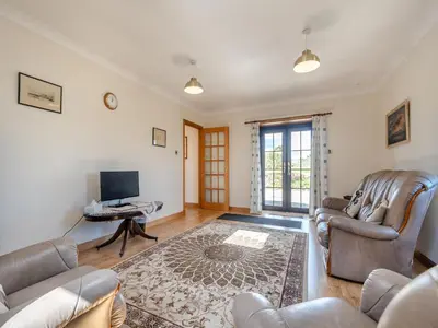 a living room with two couches and a tv at Eryb Cottage - Uk46883 in Kilmory