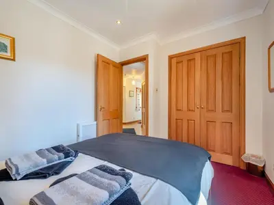a bedroom with a large bed with towels on it at Eryb Cottage - Uk46883 in Kilmory